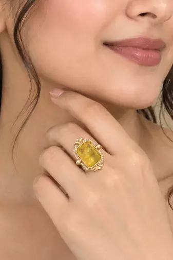 Elegant golden yellow gemstone statement ring with clear stone border