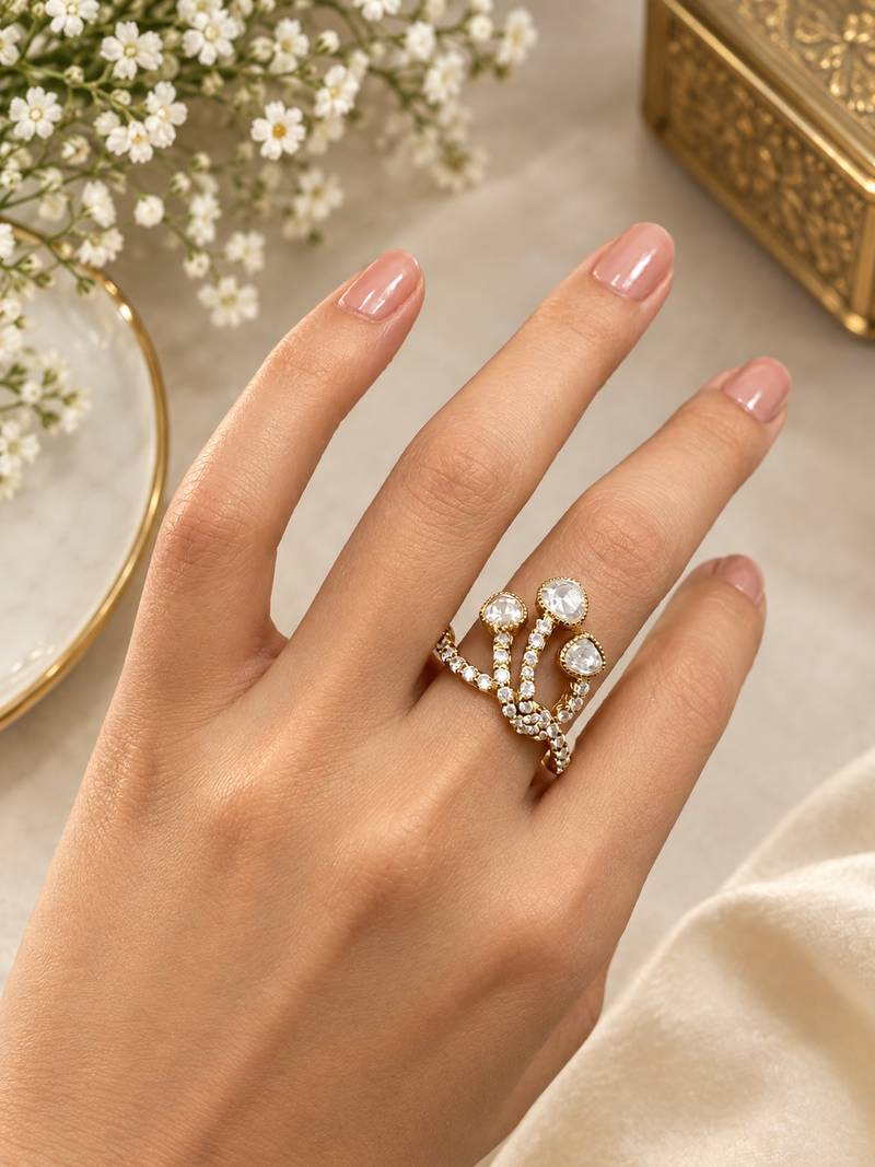 Elegant gold tone crown design statement ring with clear stone accents