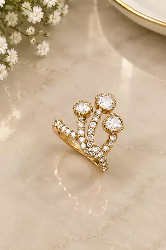 Elegant gold tone crown design statement ring with clear stone accents