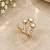 Elegant gold tone crown design statement ring with clear stone accents