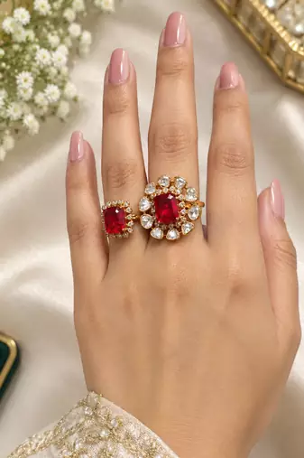 Elegant gold tone red gemstone floral statement ring with clear stone halo