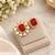 Elegant gold tone red gemstone floral statement ring with clear stone halo