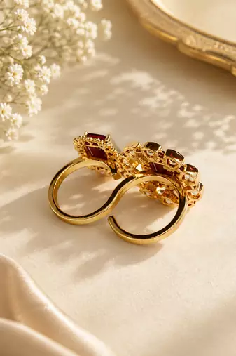 Elegant gold tone red gemstone floral statement ring with clear stone halo