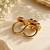 Elegant gold tone red gemstone floral statement ring with clear stone halo