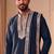 Blue lachka kurta set with silver mirror work and an attached stole.