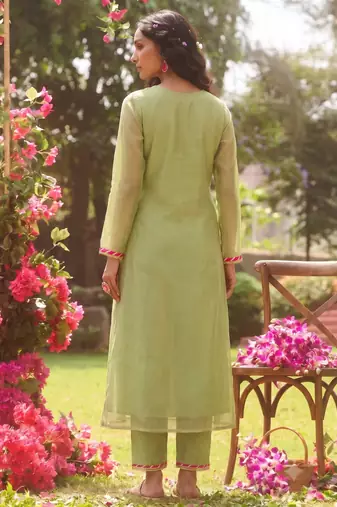 Elegant pista green tissue kurta pant set featuring palm motifs with delicate sequin and bead work, finished.