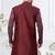 Dark maroon jacket-style indo-western set with thread and stone work, perfect for weddings and festive occasions.