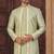 Pista green jacket-style indo-western set with thread and stone work, perfect for weddings and festive occasions.