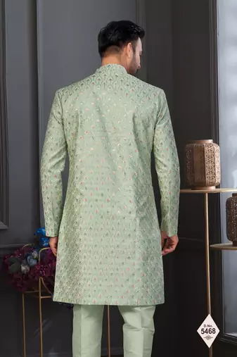 Pista green jacket-style indo-western set with thread and stone work, perfect for weddings and festive occasions.