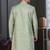 Pista green jacket-style indo-western set with thread and stone work, perfect for weddings and festive occasions.