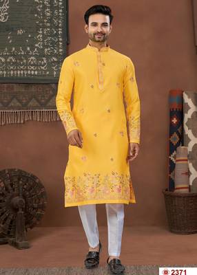 Yellow soft silk kurta pajama set with floral buti and hem embroidery—perfect for festive wear. 1