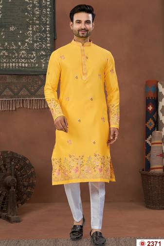 Yellow soft silk kurta pajama set with floral buti and hem embroidery—perfect for festive wear.