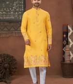 Yellow soft silk kurta pajama set with floral buti and hem embroidery—perfect for festive wear.