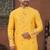 Yellow soft silk kurta pajama set with floral buti and hem embroidery—perfect for festive wear.