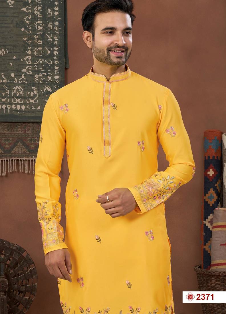 Yellow soft silk kurta pajama set with floral buti and hem embroidery—perfect for festive wear.
