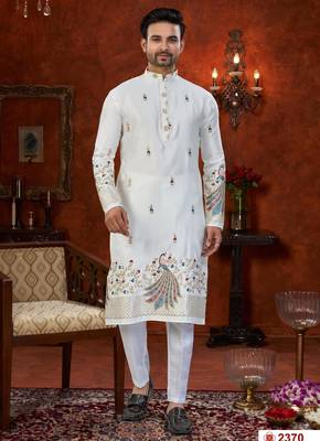 Off white soft silk kurta pajama set with floral buti and hem embroidery—perfect for festive wear. 1