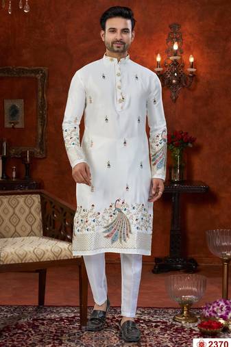 Off white soft silk kurta pajama set with floral buti and hem embroidery—perfect for festive wear.