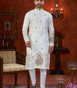 Off white soft silk kurta pajama set with floral buti and hem embroidery—perfect for festive wear.