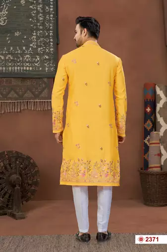 Yellow soft silk kurta pajama set with floral buti and hem embroidery—perfect for festive wear.