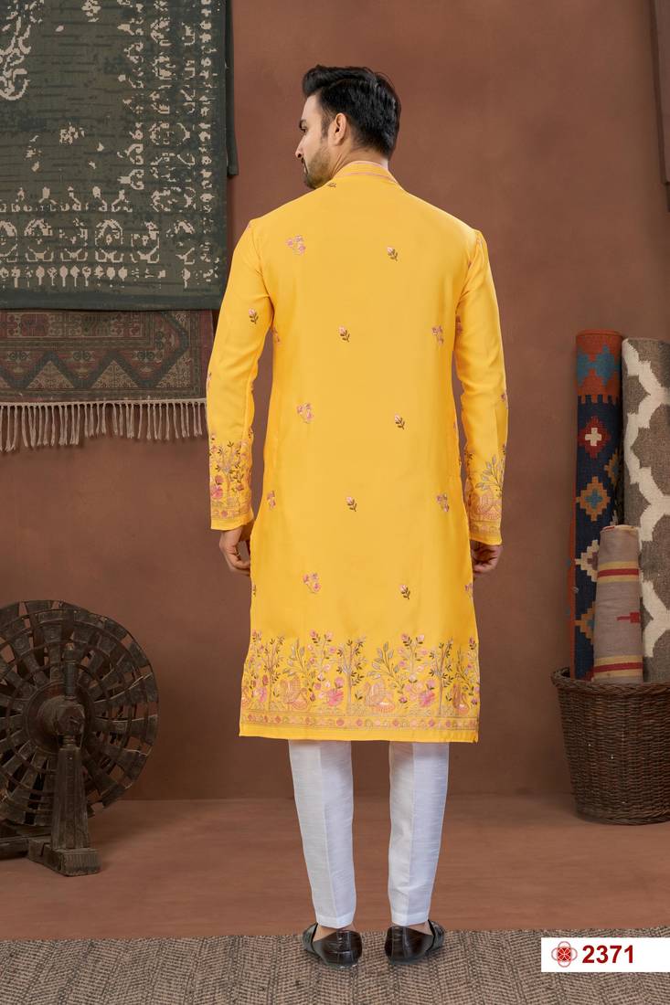 Yellow soft silk kurta pajama set with floral buti and hem embroidery—perfect for festive wear.