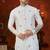 Off white soft silk kurta pajama set with floral buti and hem embroidery—perfect for festive wear.