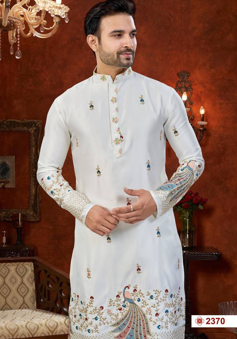 Off white soft silk kurta pajama set with floral buti and hem embroidery—perfect for festive wear.
