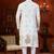 Off white soft silk kurta pajama set with floral buti and hem embroidery—perfect for festive wear.