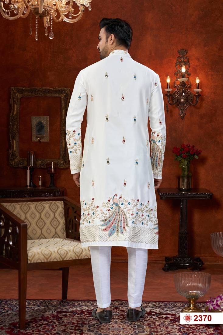 Off white soft silk kurta pajama set with floral buti and hem embroidery—perfect for festive wear.