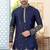 Nevy blue soft silk kurta pajama set with floral buti and hem embroidery—perfect for festive wear.