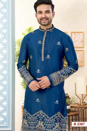 Blue soft silk kurta pajama set with floral buti and hem embroidery—perfect for festive wear.