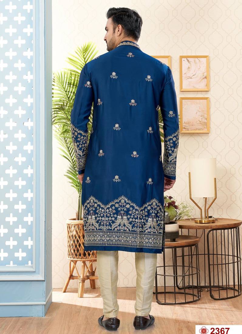 Blue soft silk kurta pajama set with floral buti and hem embroidery—perfect for festive wear.