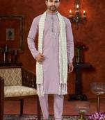 Purple soft silk kurta pajama set with beadwork on the neckline and thread embroidery on the hem.