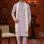 Purple soft silk kurta pajama set with beadwork on the neckline and thread embroidery on the hem.