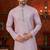 Purple soft silk kurta pajama set with beadwork on the neckline and thread embroidery on the hem.