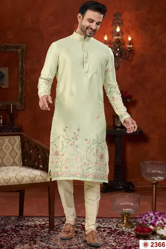 Pista green soft silk kurta pajama set with floral buti and hem embroidery—perfect for festive wear.
