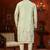 Pista green soft silk kurta pajama set with floral buti and hem embroidery—perfect for festive wear.