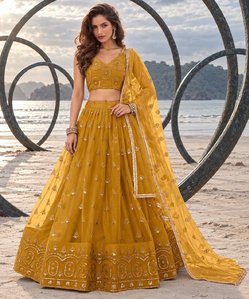 MUSTARD YELLOW NET THREAD WITH ZARI AND SEQUIN WORK FESTIVE LEHENGA CHOLI