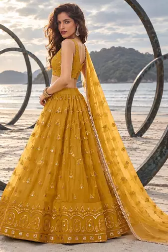 MUSTARD YELLOW NET THREAD WITH ZARI AND SEQUIN WORK FESTIVE LEHENGA CHOLI