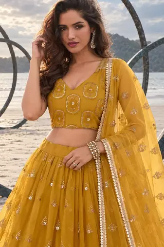 MUSTARD YELLOW NET THREAD WITH ZARI AND SEQUIN WORK FESTIVE LEHENGA CHOLI