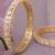 Orbiting leaf gold plated diamond bangles