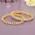 Ornate orbit solitaire gold plated bangles