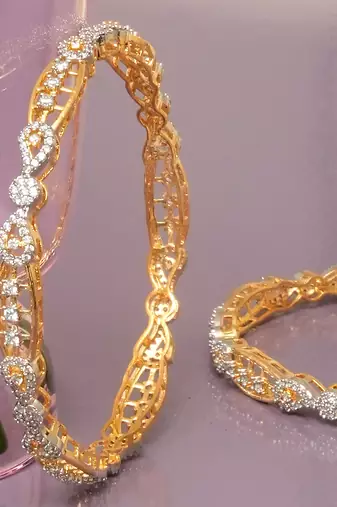 Swirling  solitaire gold plated diamond bangles