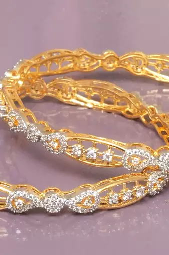 Swirling  solitaire gold plated diamond bangles