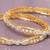 Swirling  solitaire gold plated diamond bangles