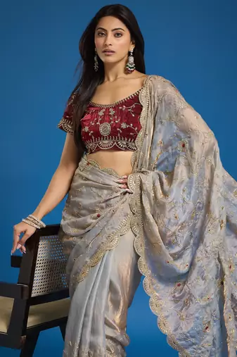 Grey tissue satin embroidered saree with unstitched blouse piece.