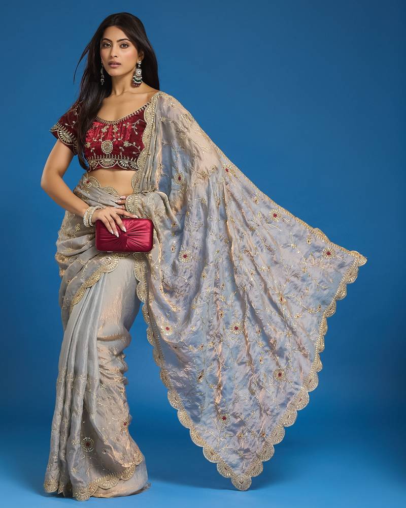 Grey tissue satin embroidered saree with unstitched blouse piece.