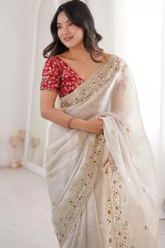 Beige tissue satin embroidered saree with unstitched blouse piece.