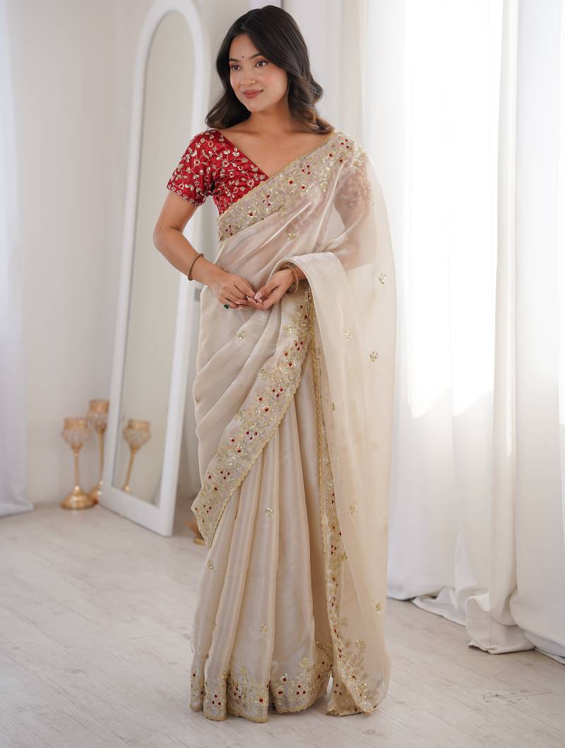 Beige tissue satin embroidered saree with unstitched blouse piece.