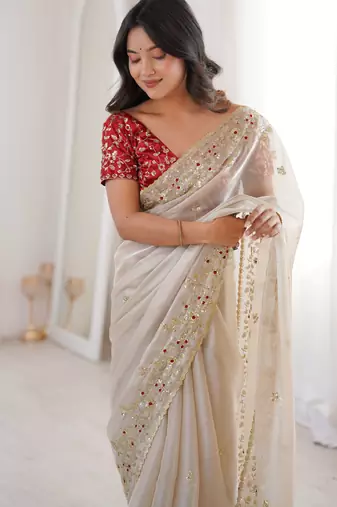 Beige tissue satin embroidered saree with unstitched blouse piece.