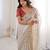 Beige tissue satin embroidered saree with unstitched blouse piece.